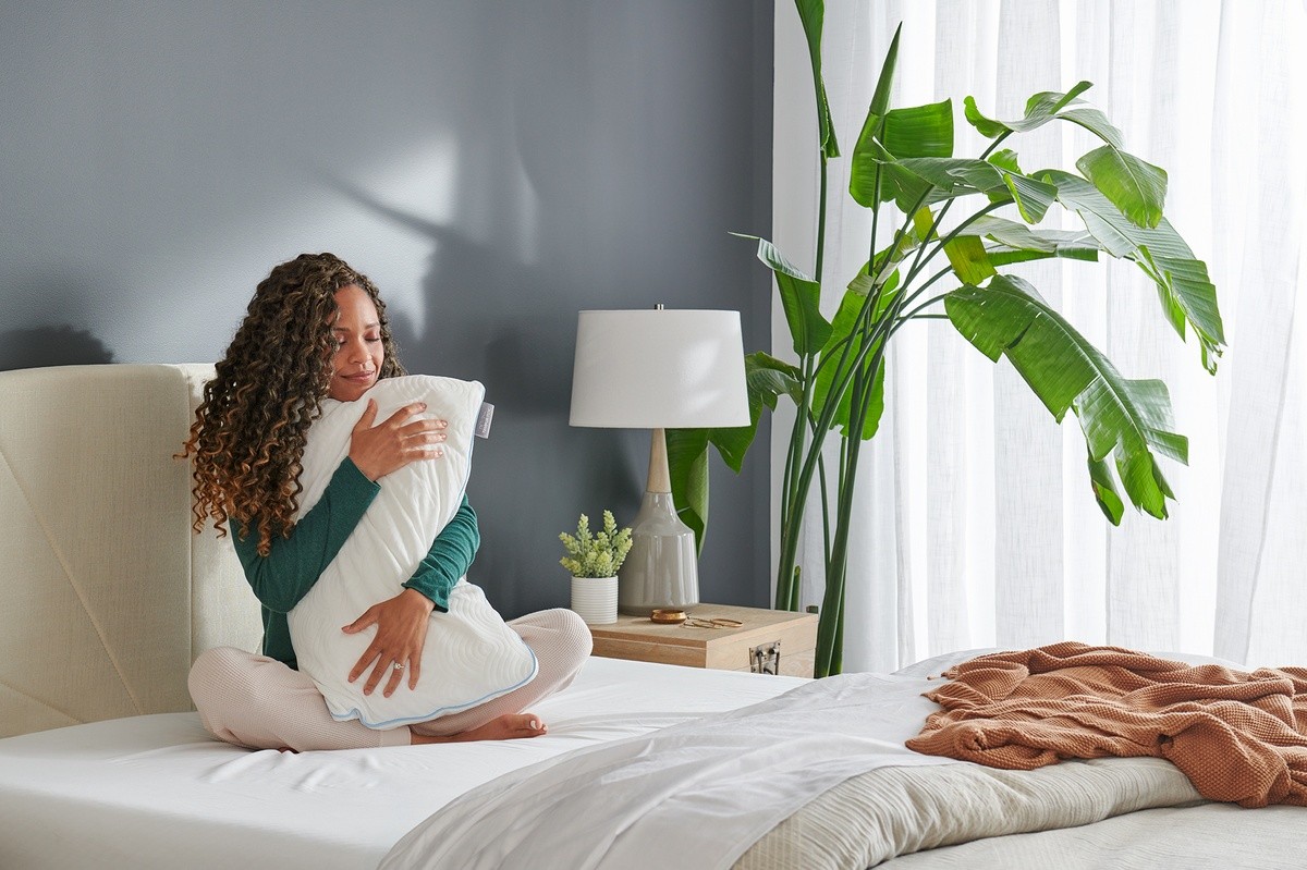 Woman hugging a TEMPUR-Cloud Adjustable Pillow