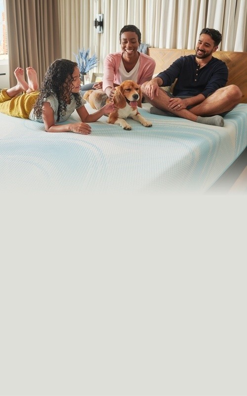 Family lounging with dog on their Tempur mattress - Mobile View