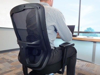 man sitting in black office chair at a desk