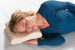 Woman laying on NeckPillow - Travel