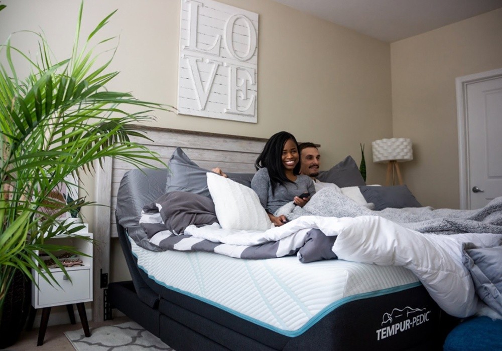 A happy couple on a Tempur-Pedic Mattress