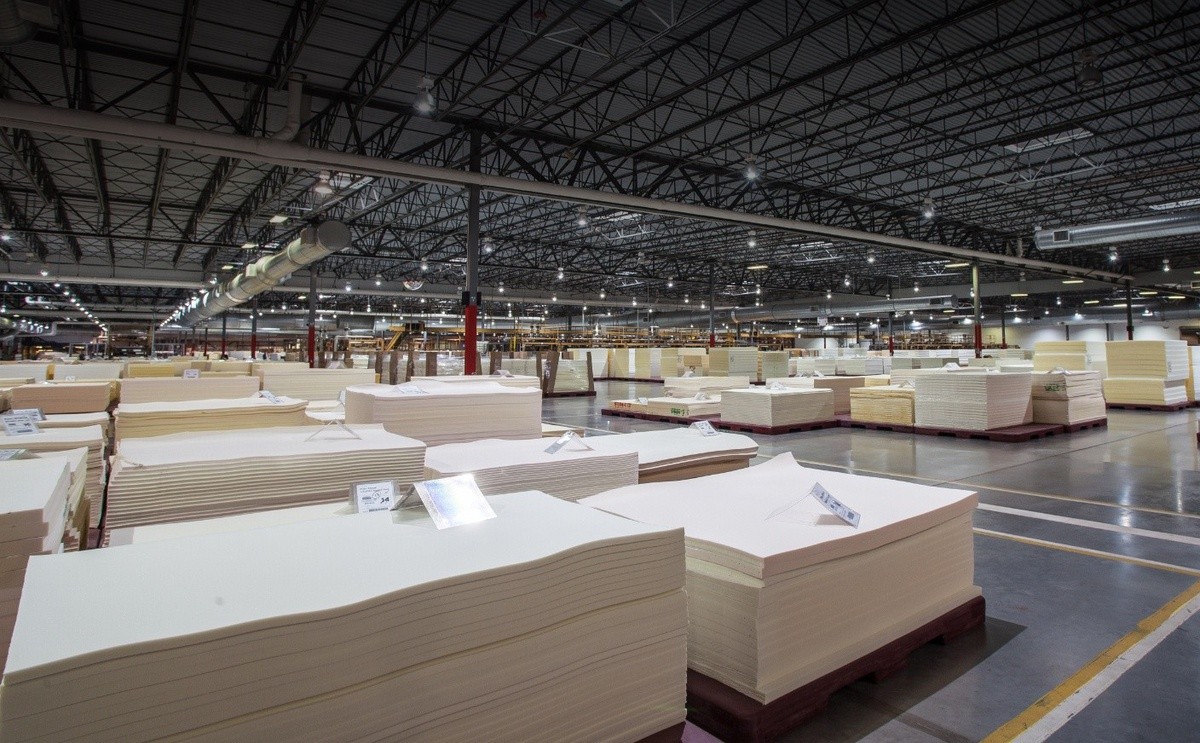 Inside image of large Tempur-Pedic factory with stacks of tempur material