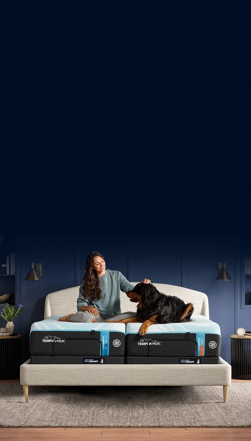 A family laying on a LuxeBreeze mattress in a decorated room