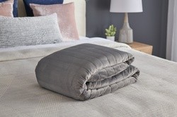 Tempur-Pedic Weighted Blanket folded on a dressed bed