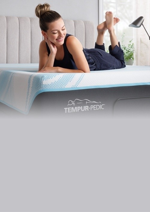 Woman lounging on her Tempur mattress