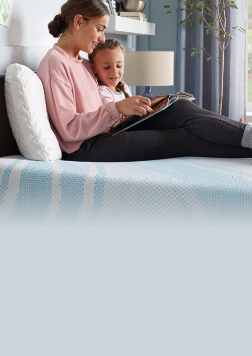 Woman reading with child on their Tempur mattress