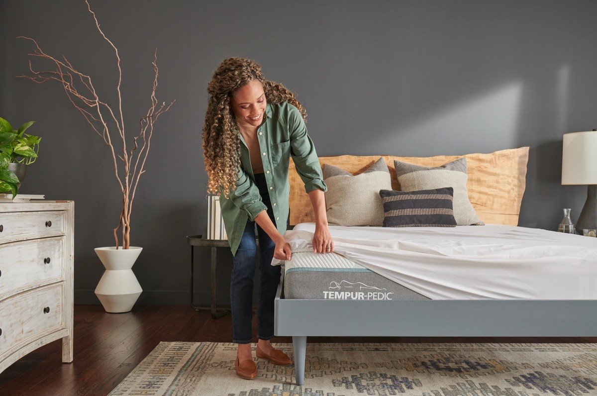 Women adding a mattress protector to a breeze mattress