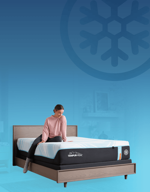 Woman laying on a Breeze mattress with Breeze Snowflake icon on the background