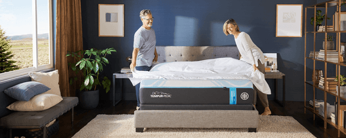 Couple in a fully dressed bedroom, putting sheets on their Queen, Soft, LuxeBreeze mattress