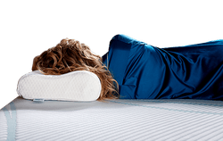 Woman laying on Tempur-neck pillow on a Tempur-Pedic mattress