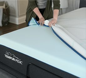 A cover being removed from a Tempur_pedic mattress