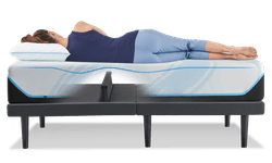 A woman laying on an Ergo Base with the Lumbar Support feature raised