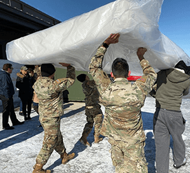 US Service Members carrying a Tempur-Sealy mattress