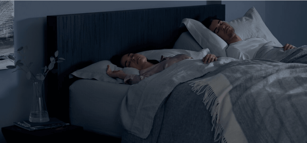 a couple sleeping in their split king Tempur mattress