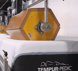 A Tempur-Pedic mattress being tested at a lab